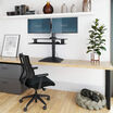 varidesk electric dual monitor converter in black in a raised position on desk 