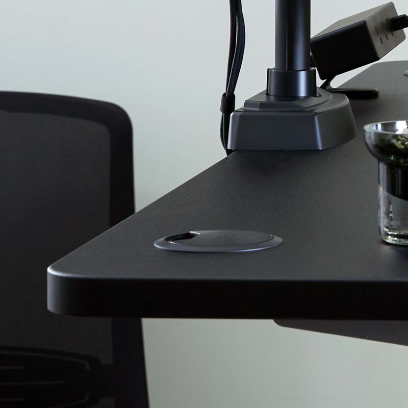 closeup of cable passthrough and grommet featured on the curve electric standing desk 60 by 30 image number null