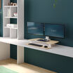 varidesk electric dual monitor converter in light wood in a lowered position on desk 
