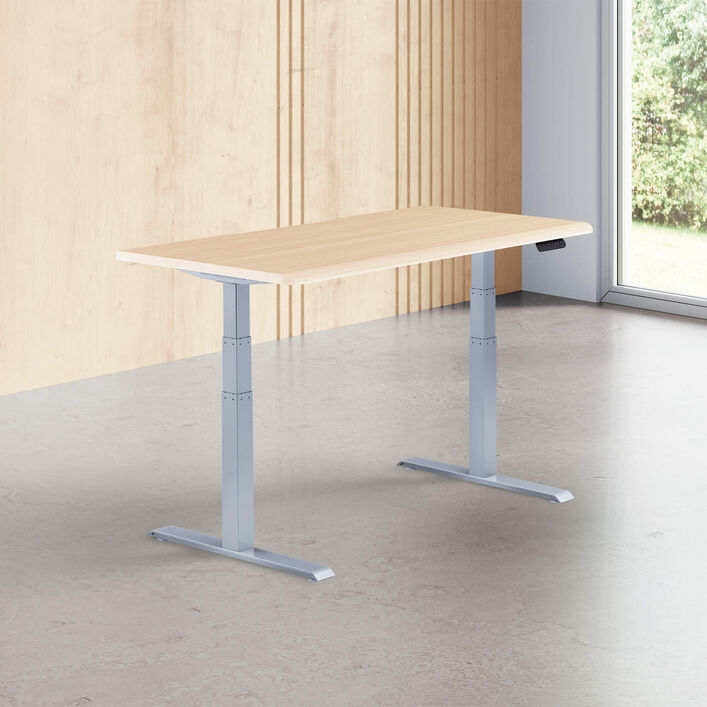 light wood finish standing desk top with silver legs in a open office image number 0