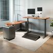 vari electric standing desk, table, and accessories in home office