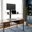 varidesk electric single monitor converter in walnut in a raised position on desk 