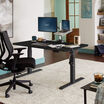 Electric Standing Desk 60x30 Black in lowered position at home