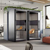 one person privacy booth in the black finish against a wall in an office space angled view