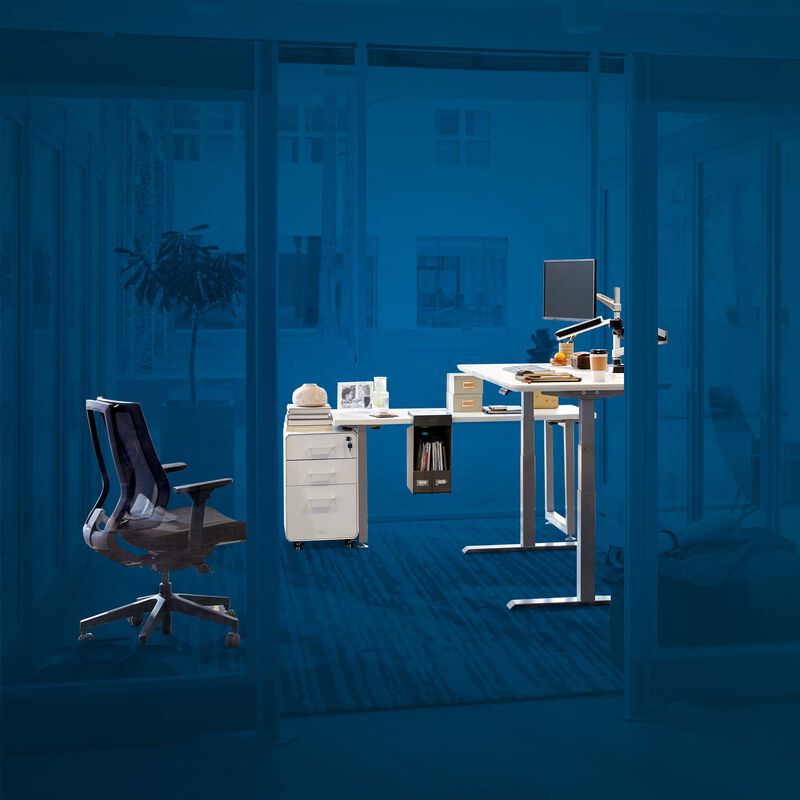 Storage friendly workspace comprised of vari electric standing desk, task chair, table, file cabinet, monitor and laptop stand, and hanging desk cubby with blue background image number null