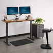 Electric Standing Desk 60 by 24 in raised position in office setting