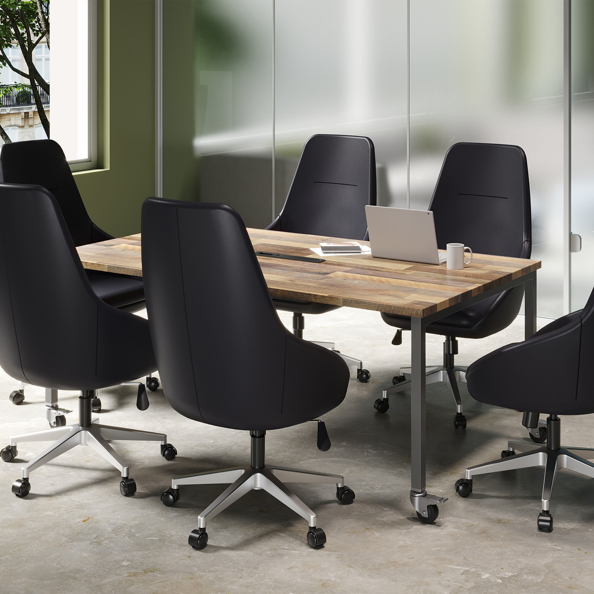 Black conference table with black ergonomic chairs and a laptop.