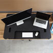 Overhead view of the VariDesk Pro Plus 48 Black sit-stand desk converter lowered on a wooden desk