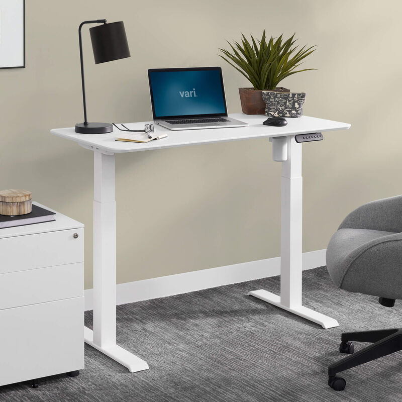 vari essential electric standing desk in white in office setting image number null