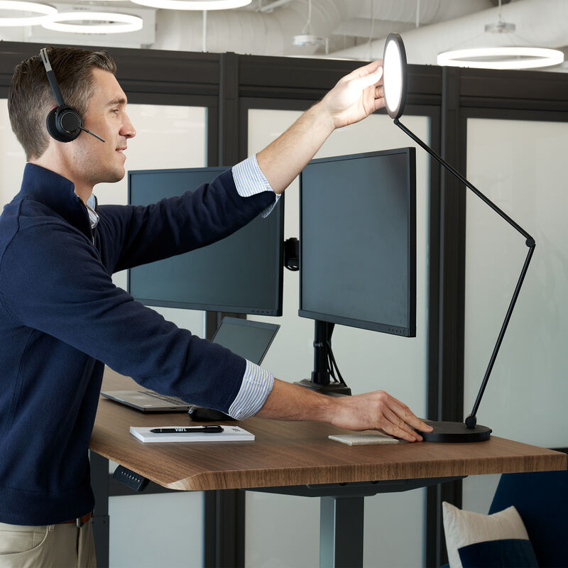 studio lamp being adjusted to use when on a conference call in an open workspace image number null