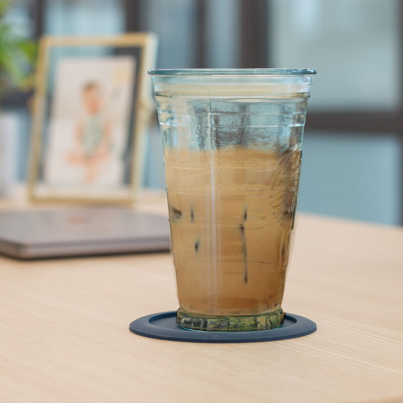 iced drink sitting on a coaster on a vari table top image number null