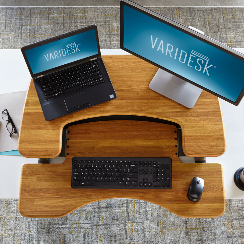 Overhead view of the VariDesk Pro Plus 36 Butcher Block sit-stand desk converter lowered on a wooden desk image number null