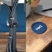 split image of cable ties on the back of a desktop screen cords and a vari coaster on a desk 