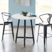 Standing Round White Table in a cafe setting. 
