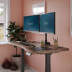 walnut finish standing desk in a home office setting