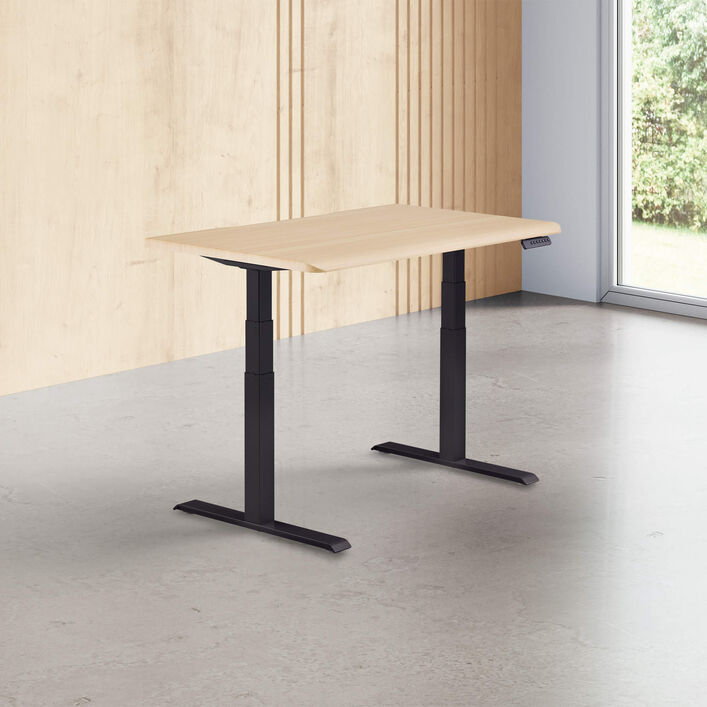 light wood finish standing desk top with black legs in a open office image number 0
