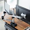 Overhead view of Monitor Arm + Laptop Stand mounted to desk with one monitor and laptop