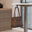 vari undermount bag hook attached to desk with a purse hanging on