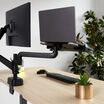 back view of a laptop sitting on top of the laptop holder installed on a desk