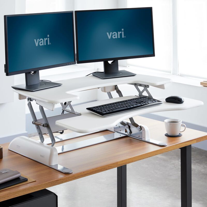 varidesk pro plus 36 white sit-stand desk converter in raised position at office image number null