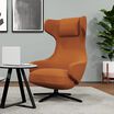 Burnt orange high back lounge chair in office setting 