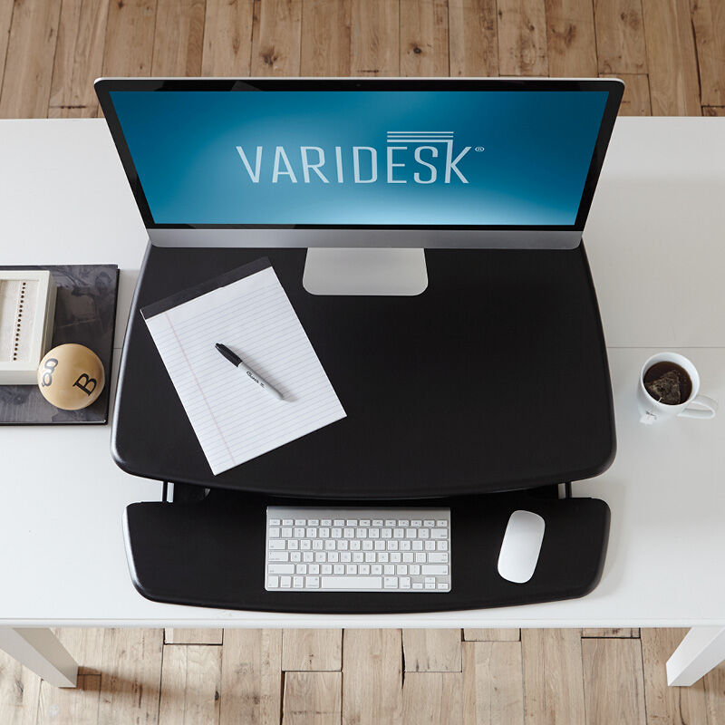 Overhead view of the VariDesk Pro 30 Black sit-stand desk converter lowered on a wooden desk image number null