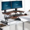 VariDesk Pro Plus 36 Darkwood sit-stand desk converter in raised position in office image