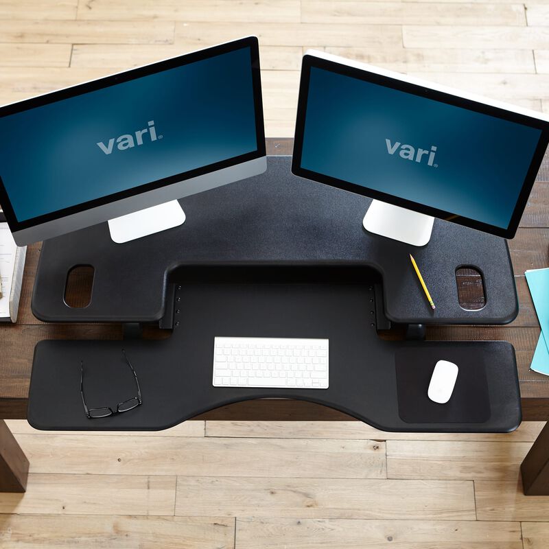 Overhead view of the VariDesk Pro Plus 48 Black sit-stand desk converter lowered on a wooden desk image number null