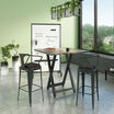 Standing height meeting table, two conference chairs, and mobile glass board in office