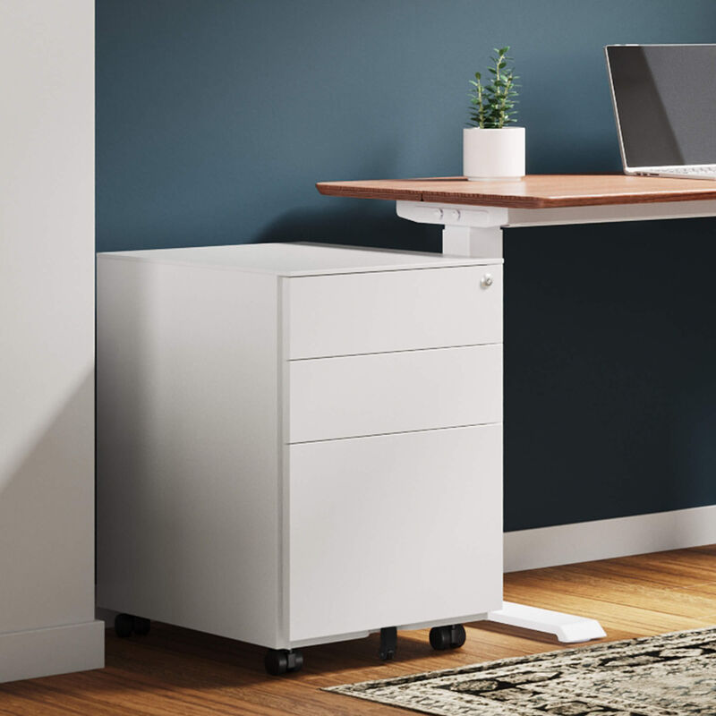 white file cabinet sitting next to a raised standing desk in a home office image number null