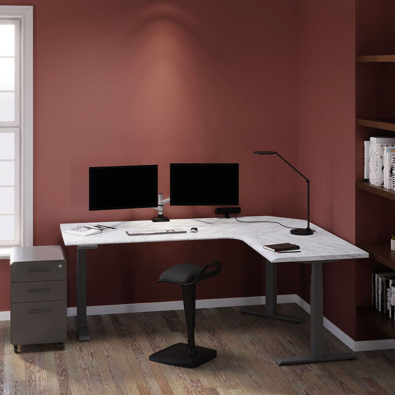 marble finish l shape electric standing desk in a lowered position in the corner of a workspace image number null