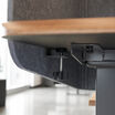 underside of the privacy desk surround attached to an electric standing desk