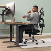 model sitting in chair stretching arm