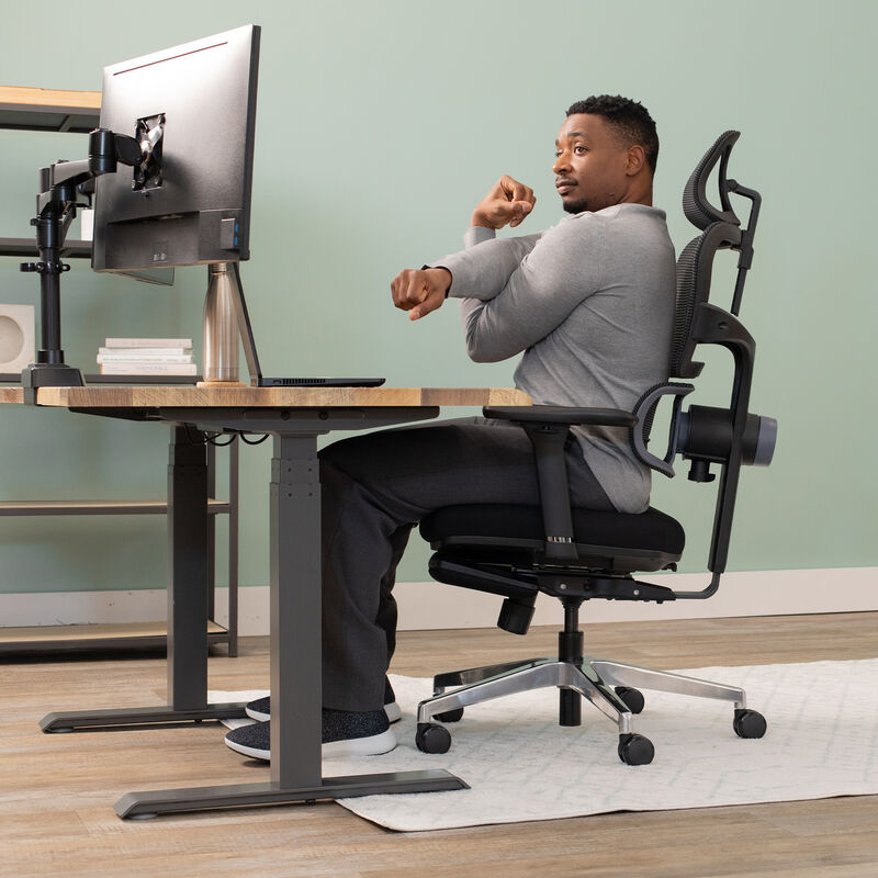 model sitting in chair stretching arm image number null