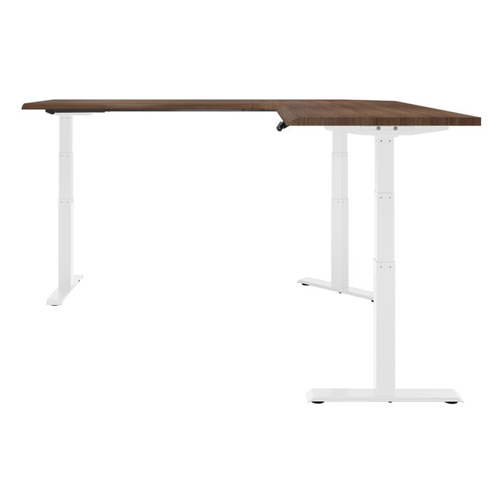 side view of an L-shape electric standing desk with a walnut finish top and white legs image number 2