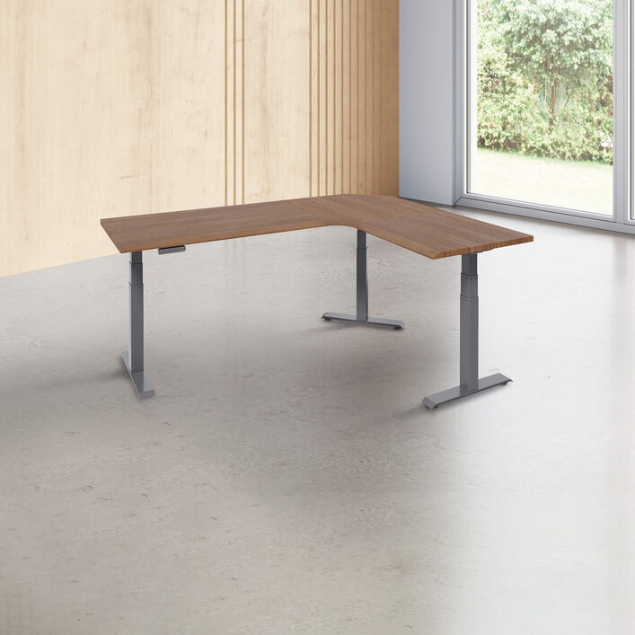 L-shape desk with a walnut finish desk top with slate legs in a open office image number 0
