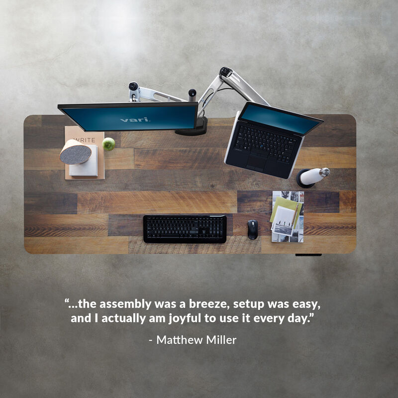 overhead image of an electric standing desk with a quote underneath reading, the assembly was a breeze setup was easy and I actually am joyful to use it everyday image number null