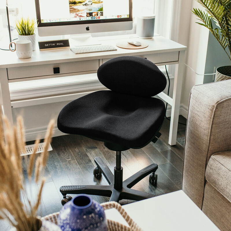 chair with a contoured seat and curved backrest placed on a wooden floor near a desk in a home office setting image number null