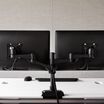 Dual-Monitor Arm 180&deg; Black mounted to desk with two monitors installed
