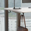 zoomed in vari undermount bag hook attached to desk with a purse hanging on
