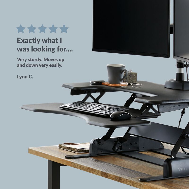 Front view of the converter in a raised position on a desk with a five star review customer quote. image number null