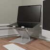 laptop on top of laptop stand sitting next to a monitor on a home office desk