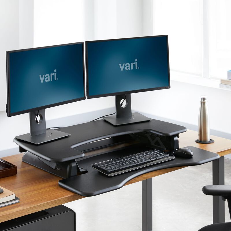 varidesk pro plus 36 black sit-stand desk converter in lowered position in office image number null