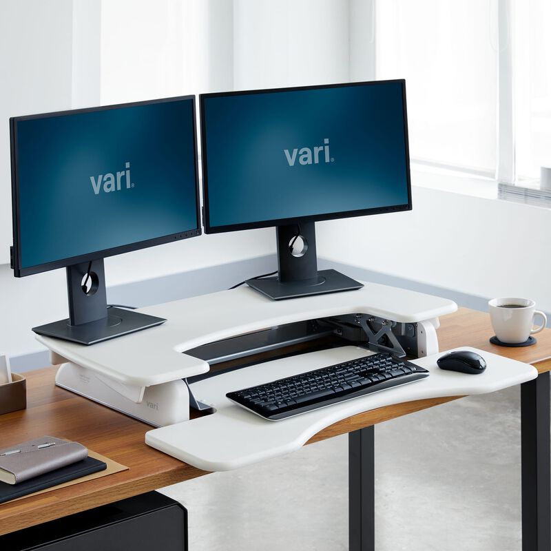 varidesk pro plus 36 white sit-stand desk converter in lowered position at office image number null