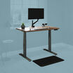 sit stand workstation bundle in a home office with a blue mask 