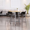 four tall wave side chairs around a tall round table in a lounge area