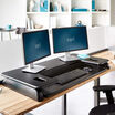 varidesk cube plus 48 in black lowered in an office