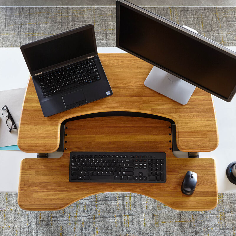 Overhead view of the VariDesk Pro Plus 36 Butcher Block sit-stand desk converter lowered on a wooden desk image number null