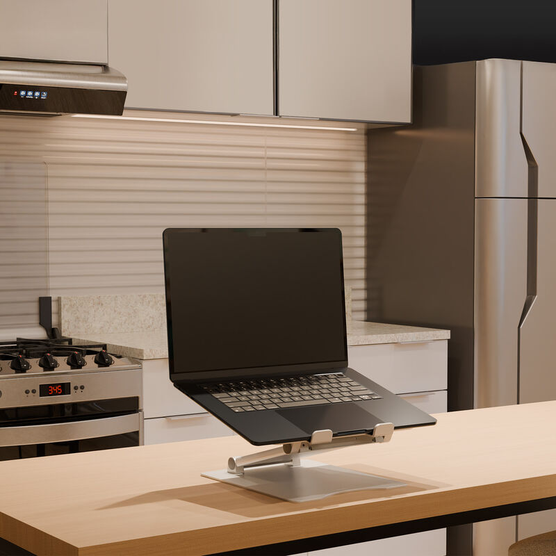 laptop stand in raised position in an apartment setting with a laptop on top of it image number null