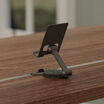 back view of tech track phone stand attached to electric standing desk 